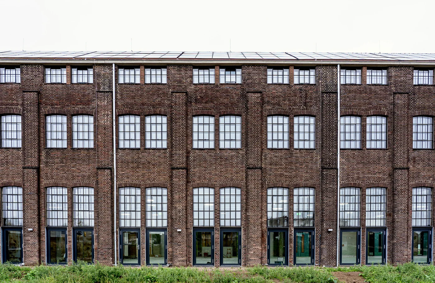 The brick front of the former printworks, three storeys of iron-framed windows.